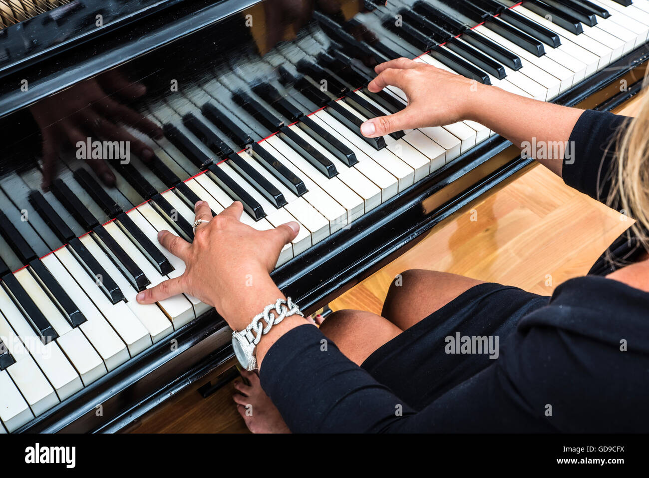 Hands of an elegant classical musician woman playing on piano. Stock Photo