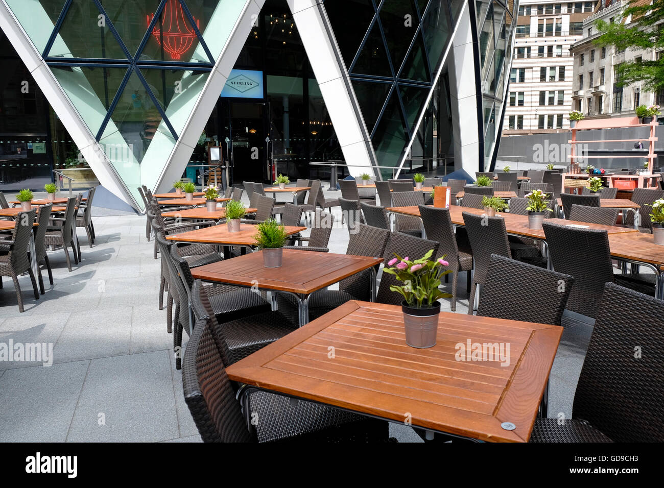 London, United Kingdom. Tables at a restaurant at the base of The Gerkin in London's CBD Stock Photo