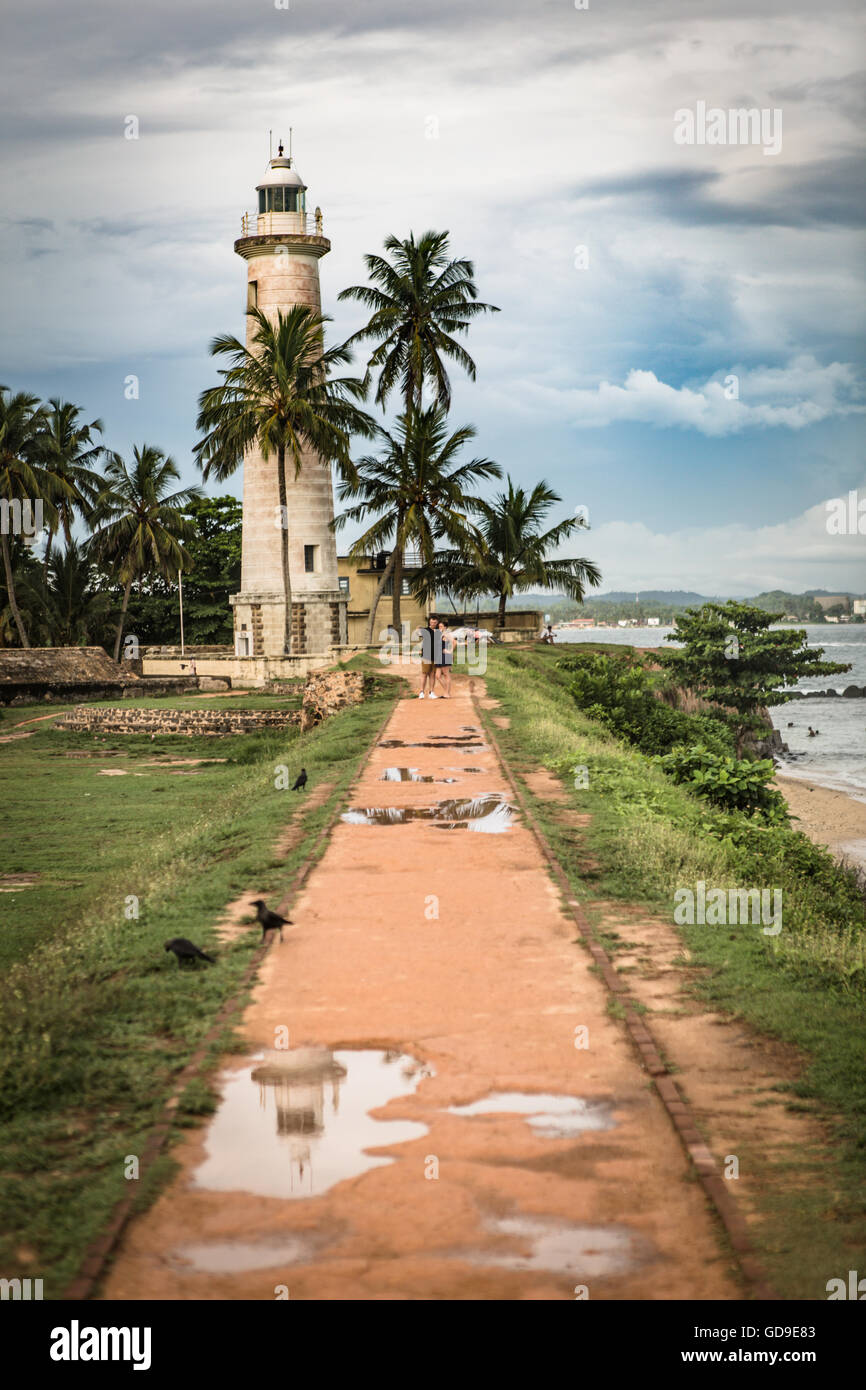 View of Galle Lighthouse, Sri Lanka after the rain, with reflection in a puddle Stock Photo
