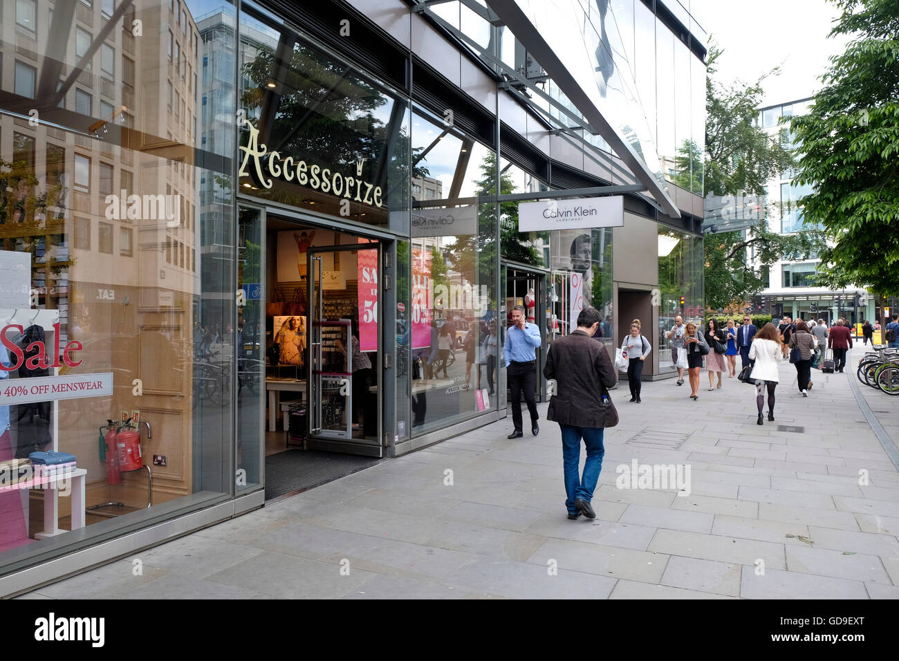 Pedestrians walk past an Accessorize retail store in the City of London