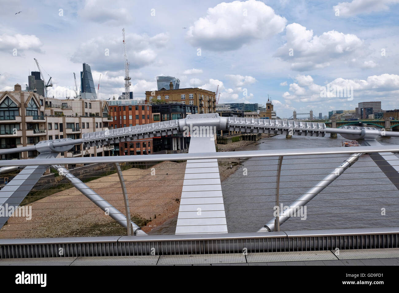 London, United Kingdom. London Skyline from the Millennium Bridge which crosses the Thames river with London's CBD and construction cranes Stock Photo