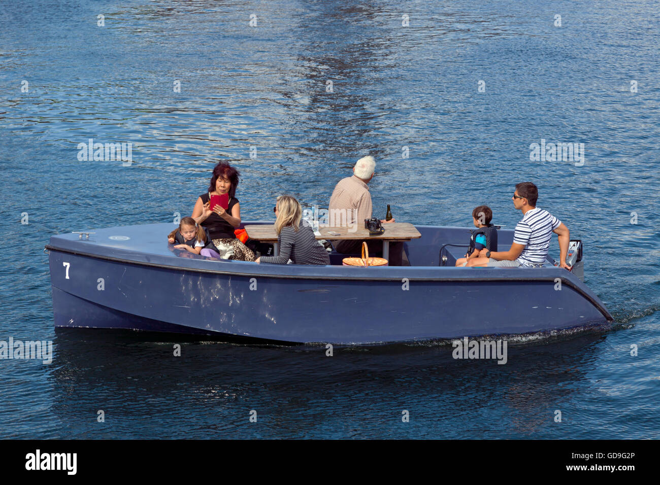 GoBoat picnic trip in the canals of Copenhagen Harbour. Denmark. Danish hygge. Old people, young adults, children. Stock Photo