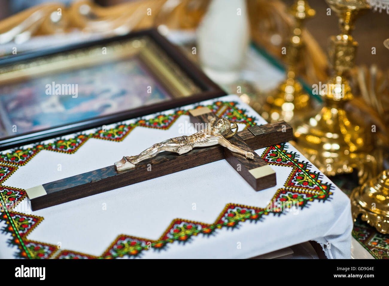 Catholic wooden cross with a crucifix on table at church Stock Photo