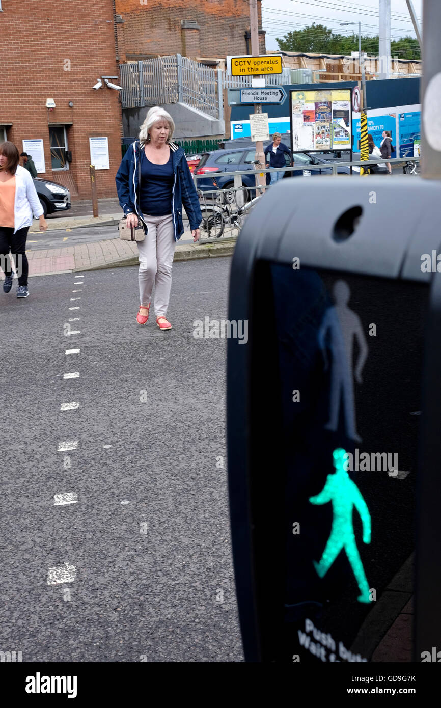 Pedestrians cross the road at a pedestrian crossing Stock Photo - Alamy