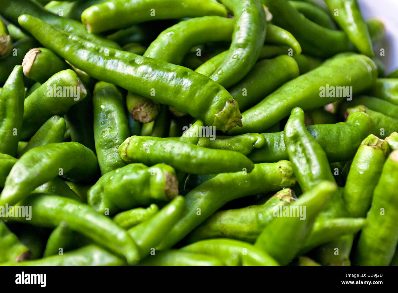 Fresh green chili peppers Stock Photo - Alamy