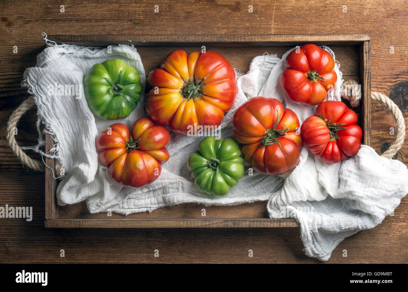 Rustic Tomato Color Heirloom tomatoes of different sizes, colors and shades in rustic ...