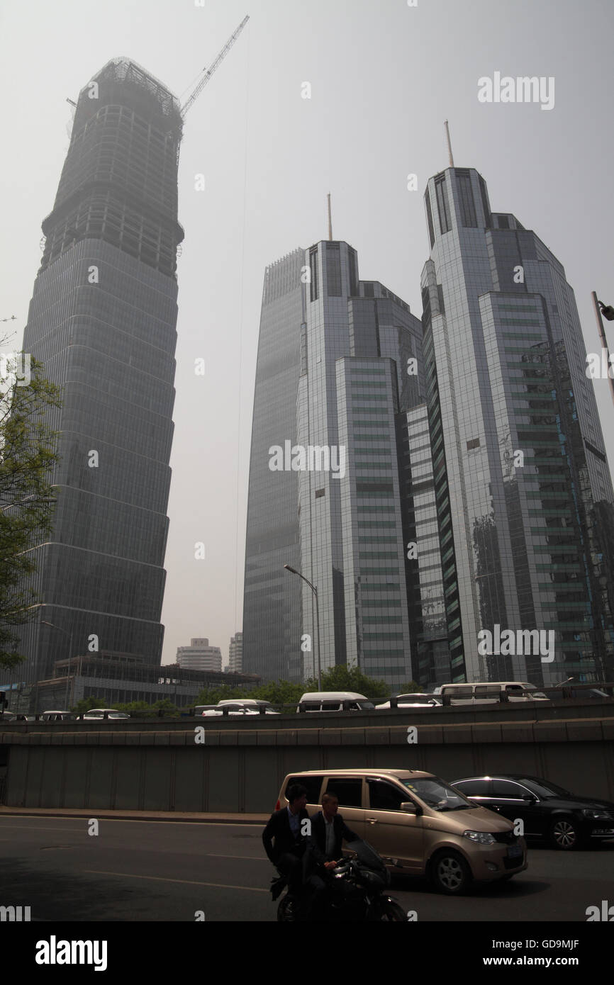 High rise commercial buildings, a highway and cars in the Centre or Center of Business District. Beijing, China. 25.04.2016 Stock Photo