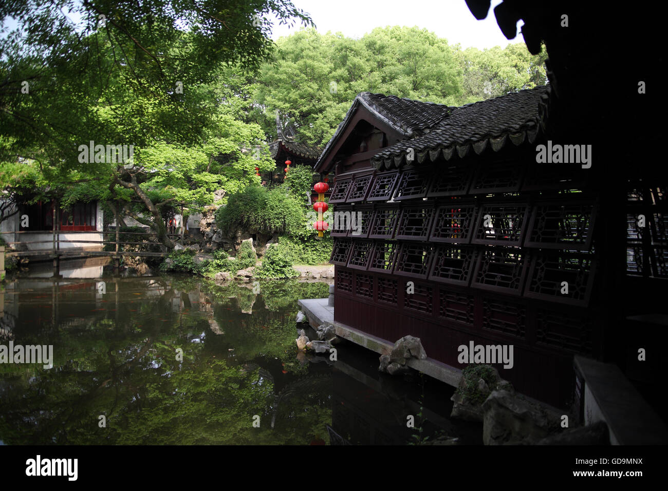 A house, a pond, vegetation and Chinese lanterns in the Tuisi Garden, a typical old Chinese garden built in 1885. Tongli, China. Stock Photo