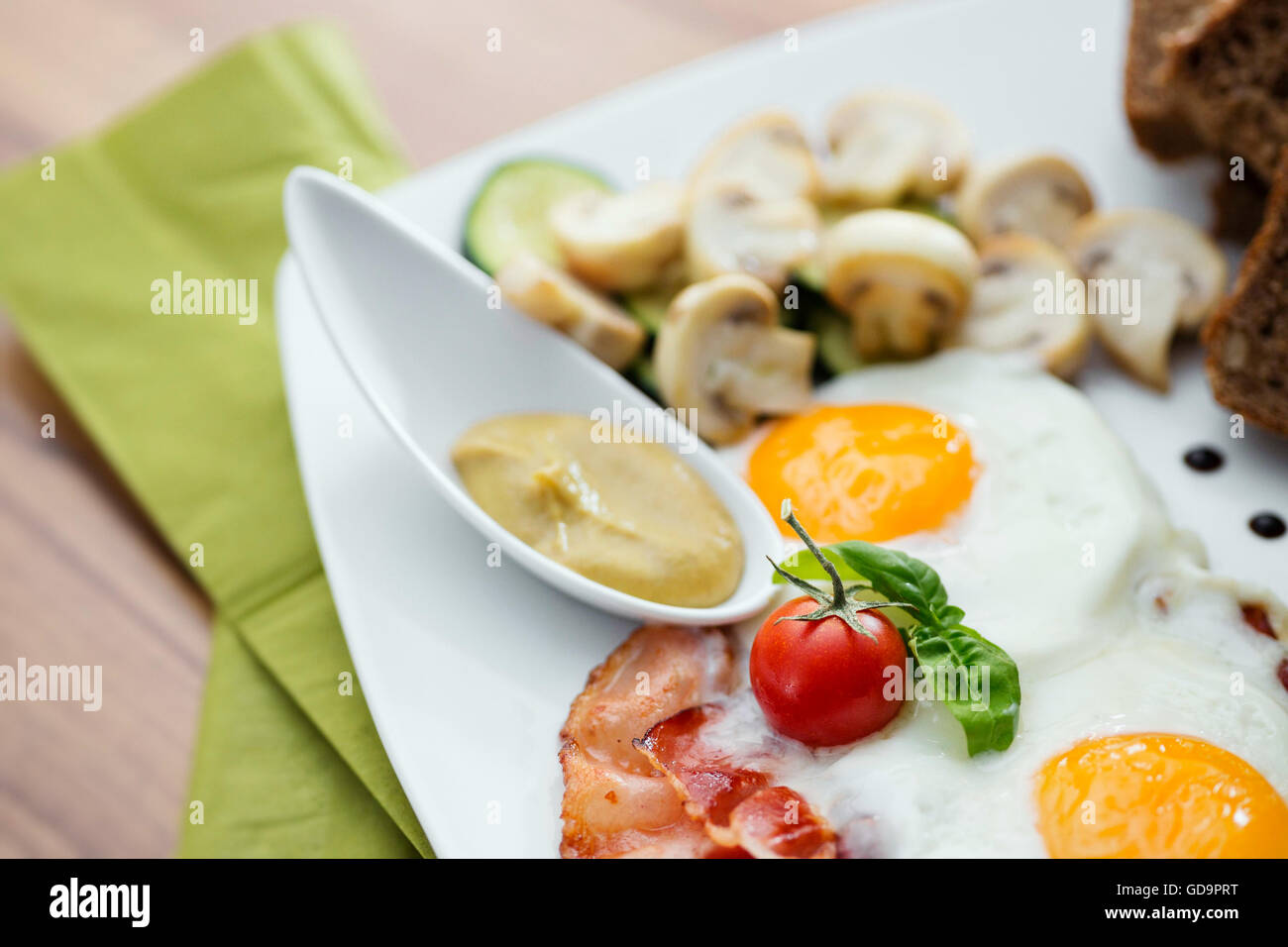 Highprotein breakfast. Fried egg with runny yolk, tomato, bacon and