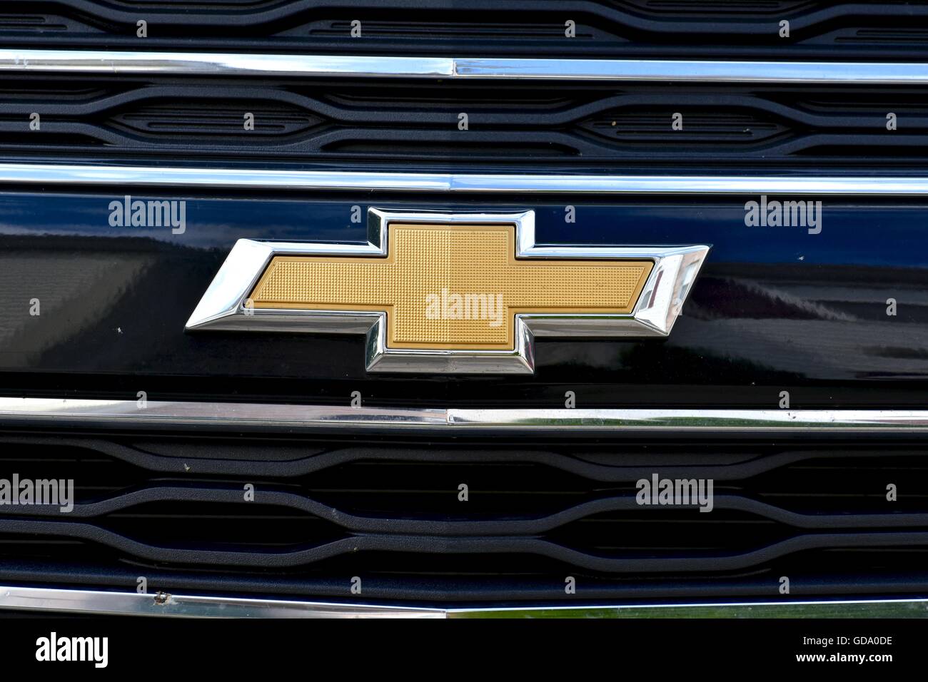 The front end of a black Chevy vehicle showing the Chevy symbol up close Stock Photo