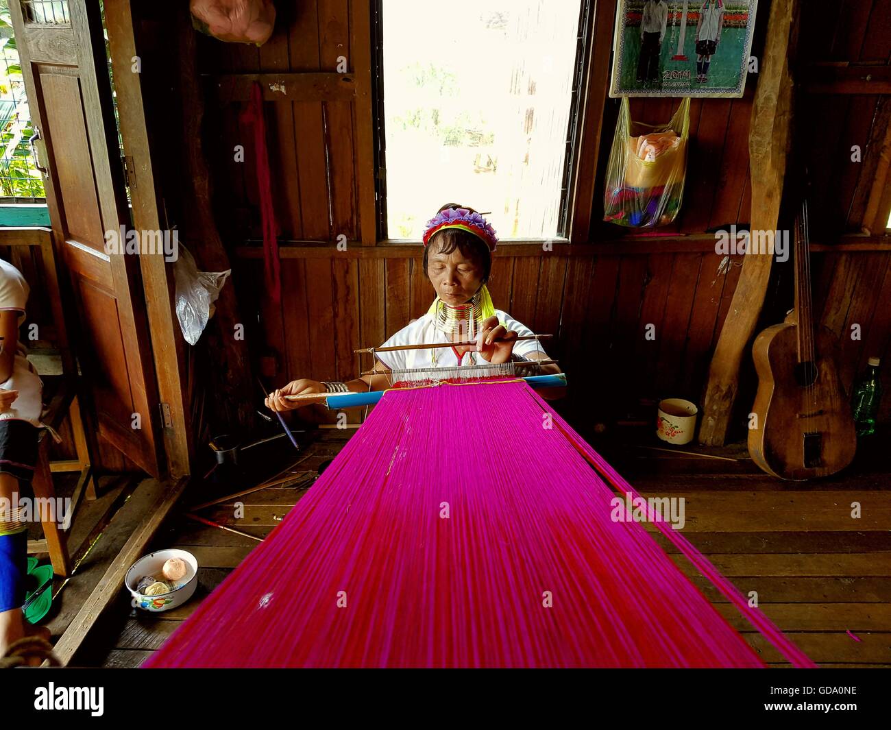 Traditional Padaung (Kayan Lahwi) Burmese woman wearing brass neck coils weaving, Inle Lake, Shan State, Myanmar, Stock Photo