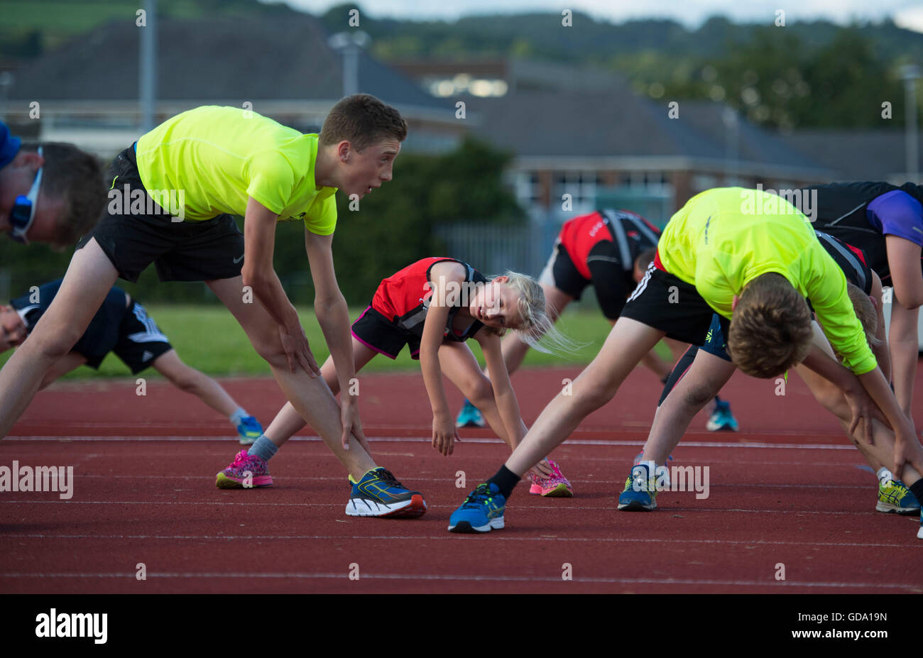 Athletes training for a triathlon on a running track in Neath, South Wales,UK. Stock Photo