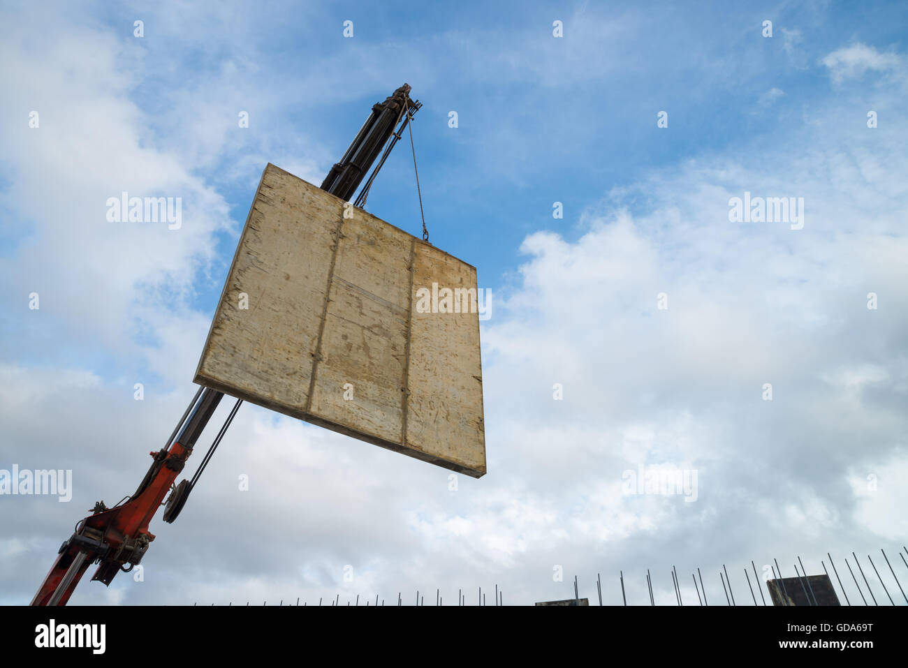 Crane lifting the encasement of a concrete panel Stock Photo