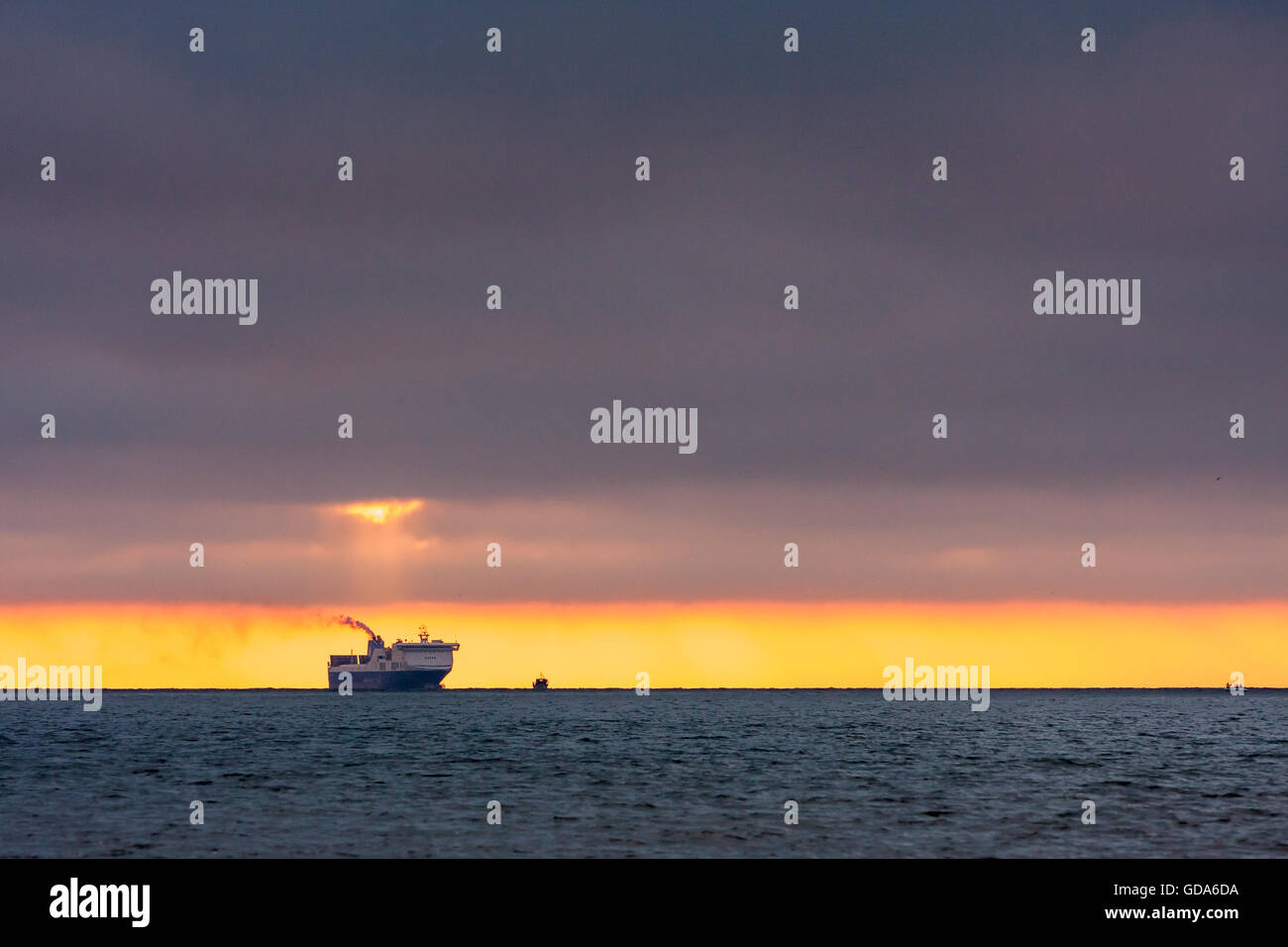Sunset,the ship on the horizon Stock Photo - Alamy
