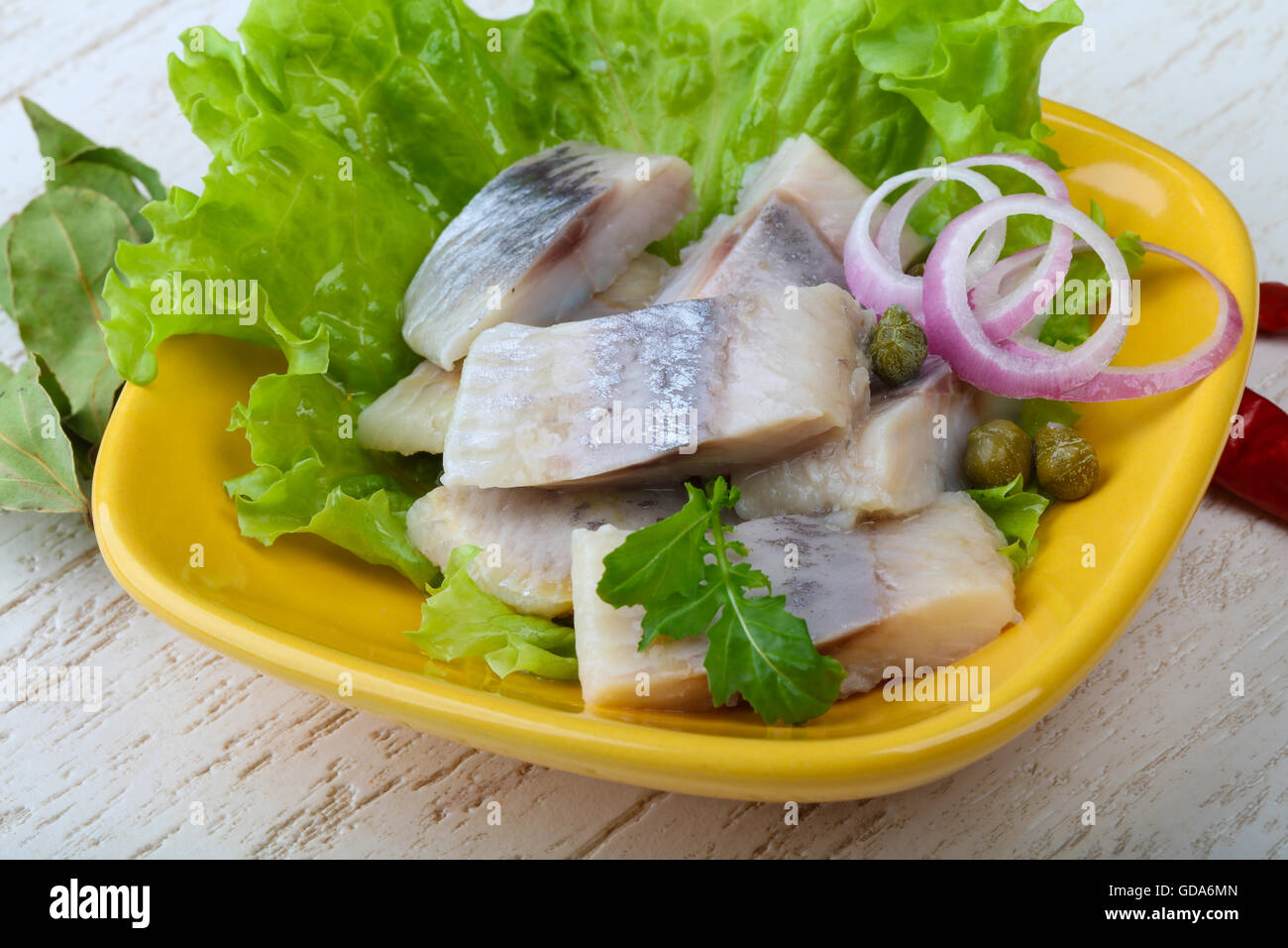 Herring fillet served onion and salad leaves Stock Photo Alamy