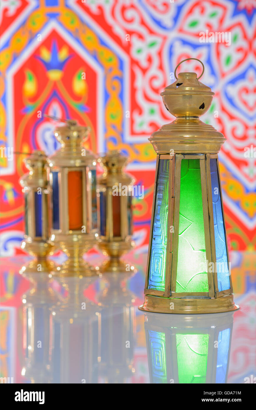 Group of Four Shiny Lanterns over Ramadan Fabric Stock Photo
