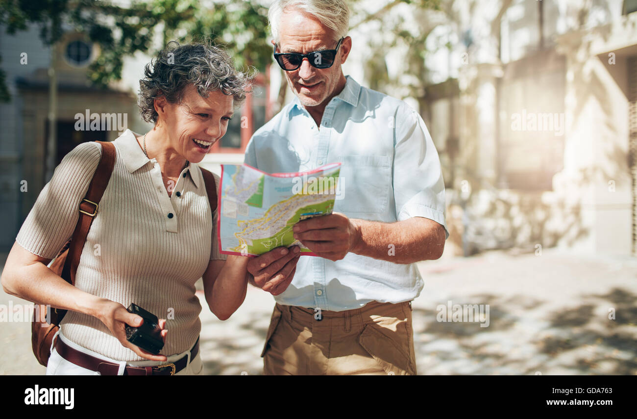 Happy family with travel map hi-res stock photography and images - Alamy