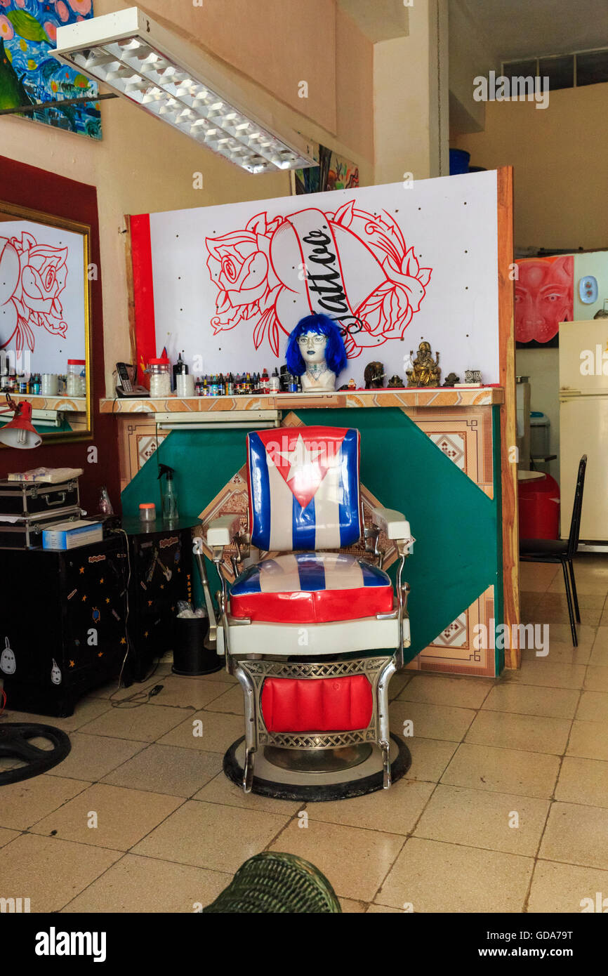 Hairdressing salon, barbershop and tattoo parlor interior with Cuban flag chair in La Habana Vieja, Havana, Cuba Stock Photo
