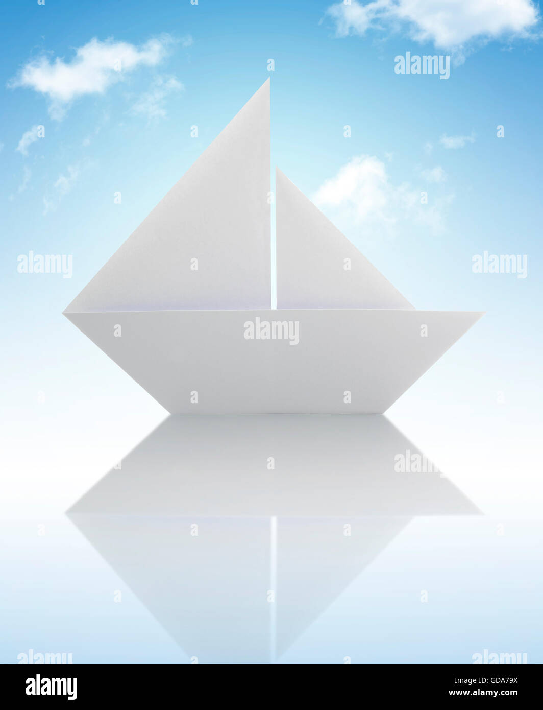 White Origami Paper Sailing Boat Under The Sky Stock Photo