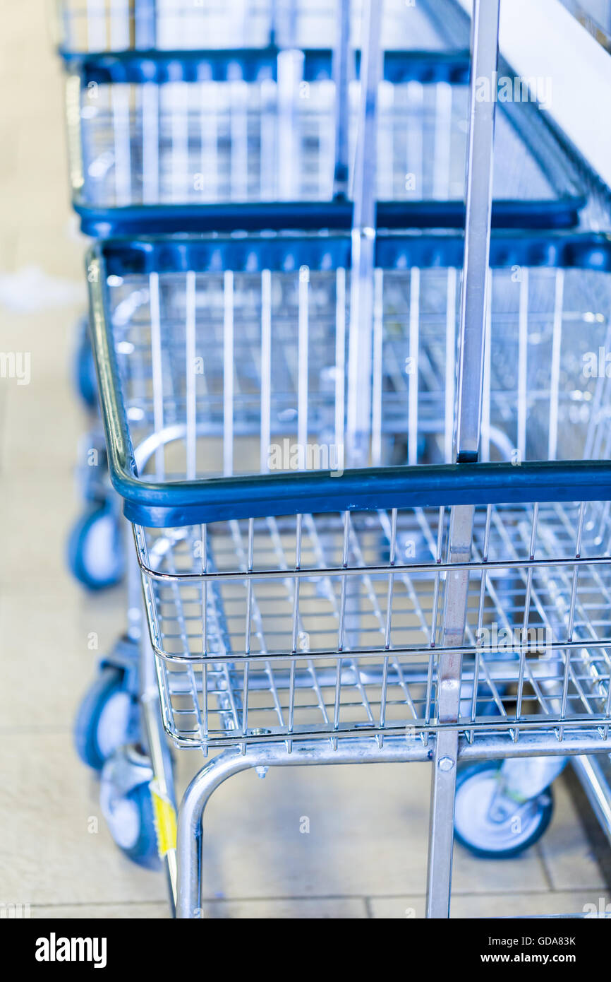 Metal laundry baskets in a public laundromat Stock Photo Alamy