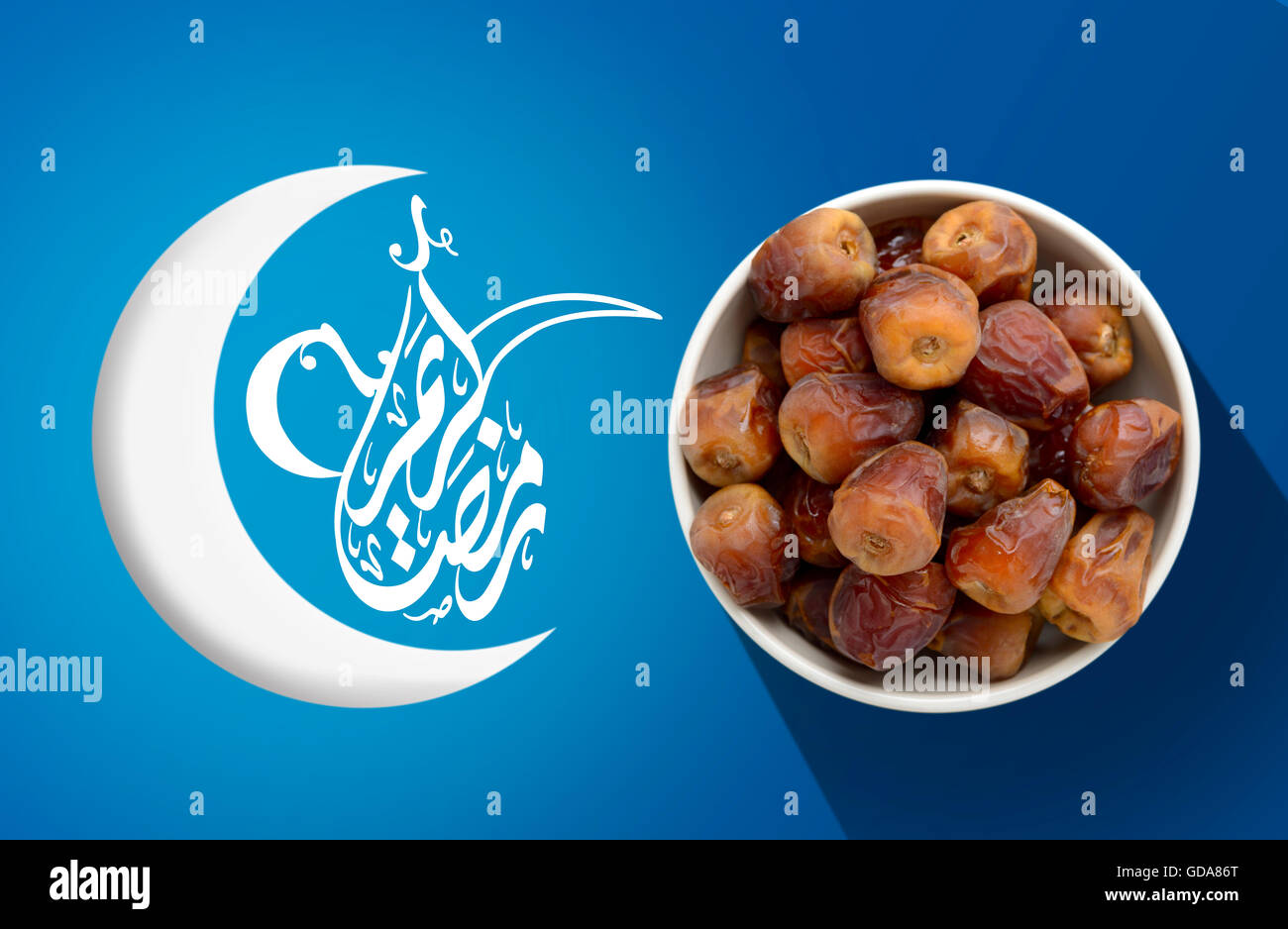 Ramadan Fasting Dates with Crescent over Blue Vivid Background Stock Photo