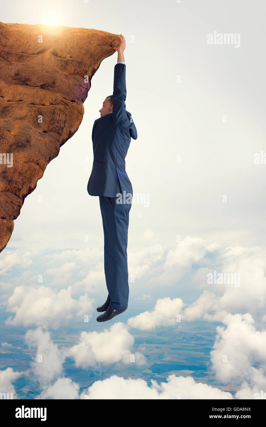 business concept challenge businessman clinging on Stock Photo