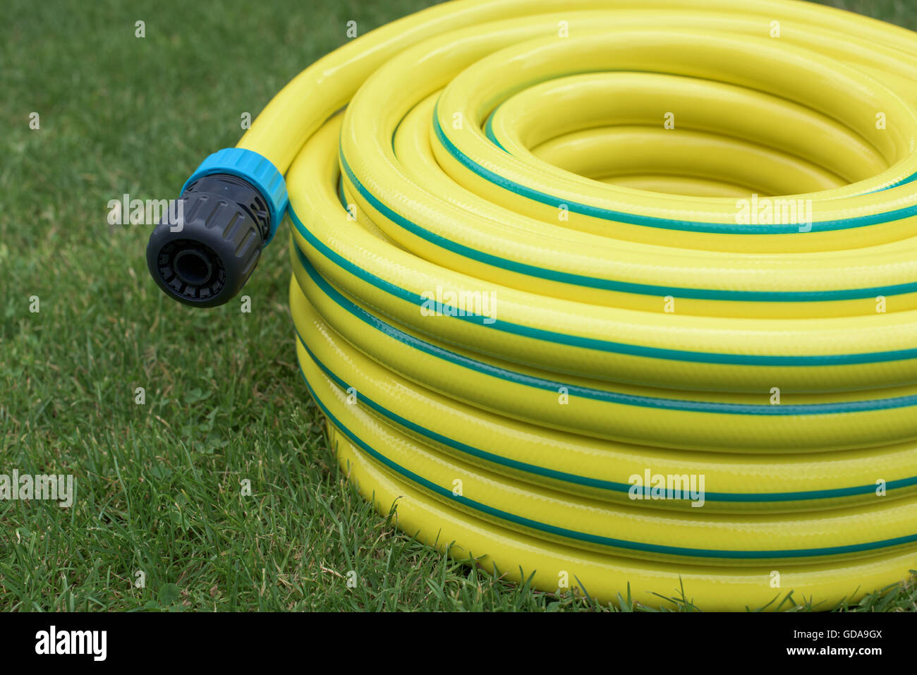 Part of yellow hose-pipe with coupling Stock Photo