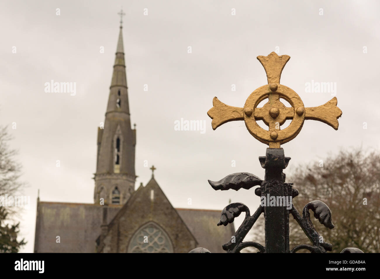 Ireland, County Meath, Cross in front of a church tower, In the city of Trim in Ireland Stock Photo