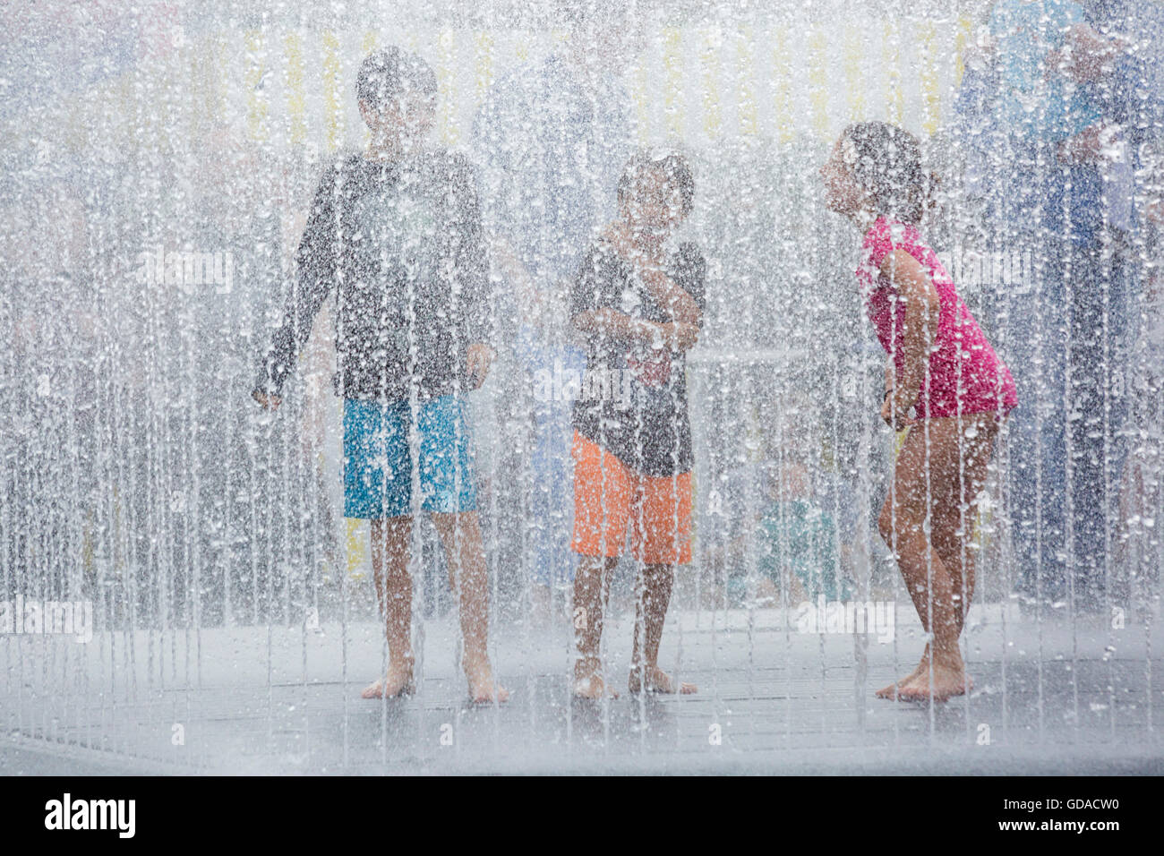 Children playing in water feature at Southbank, London in July Stock Photo