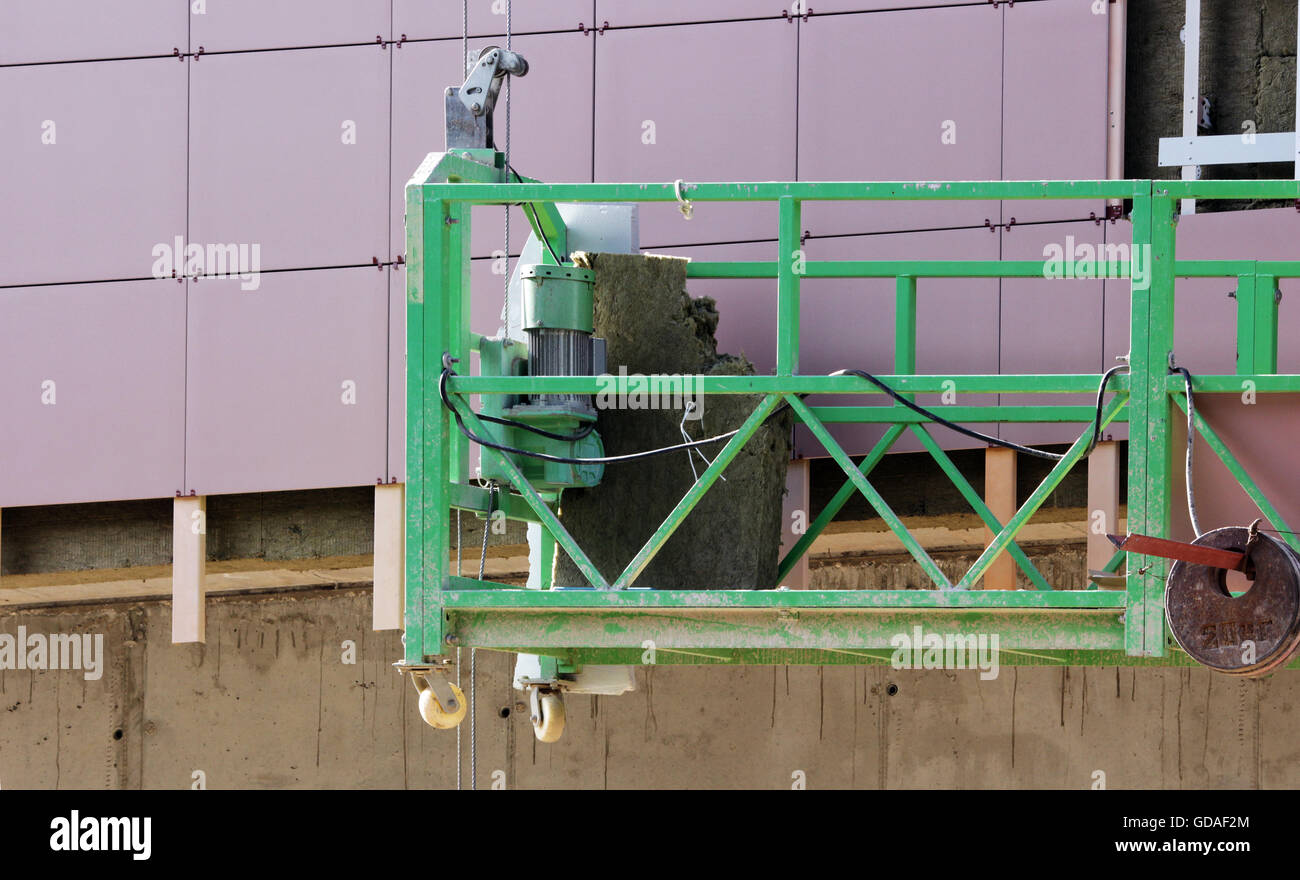 construction suspended cradle without workers on a newly built high