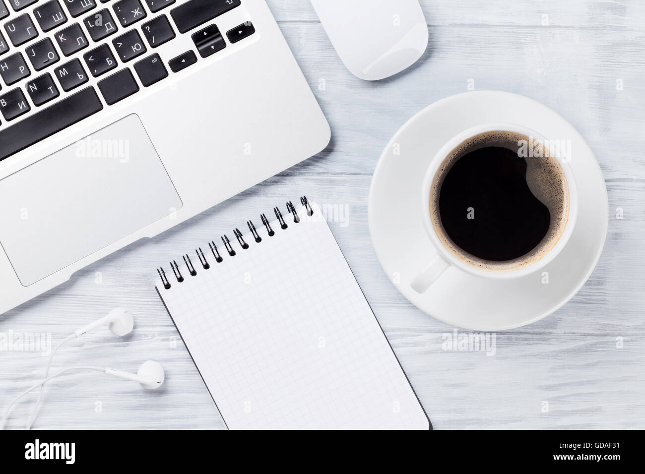 Desk table with laptop, coffee cup and notepad on wooden table ...