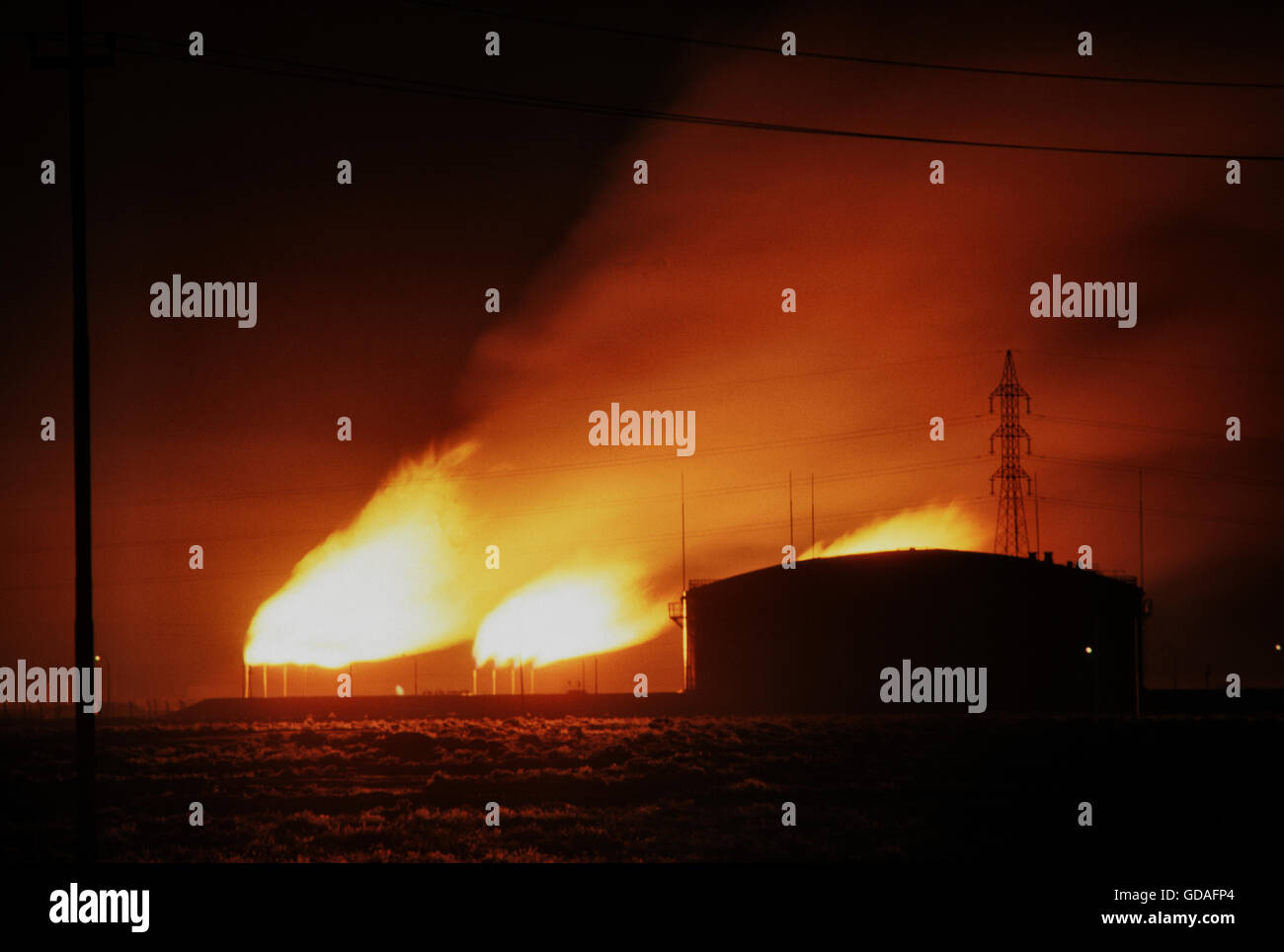 Oil storage tank and burning off natural gas from the oil fields in