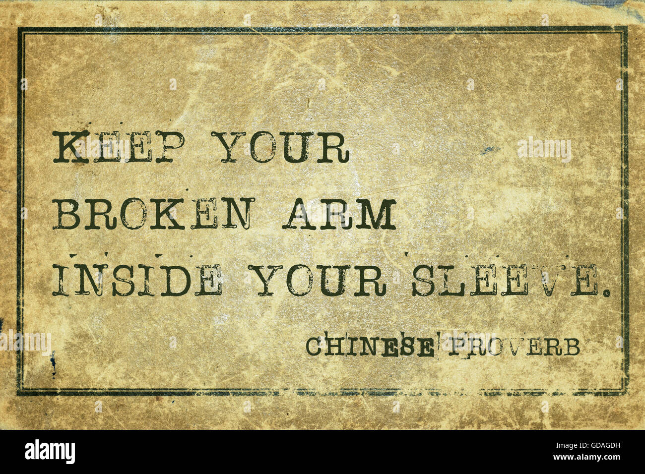 Keep your broken arm inside your sleeve - ancient Chinese proverb printed on grunge vintage cardboard Stock Photo