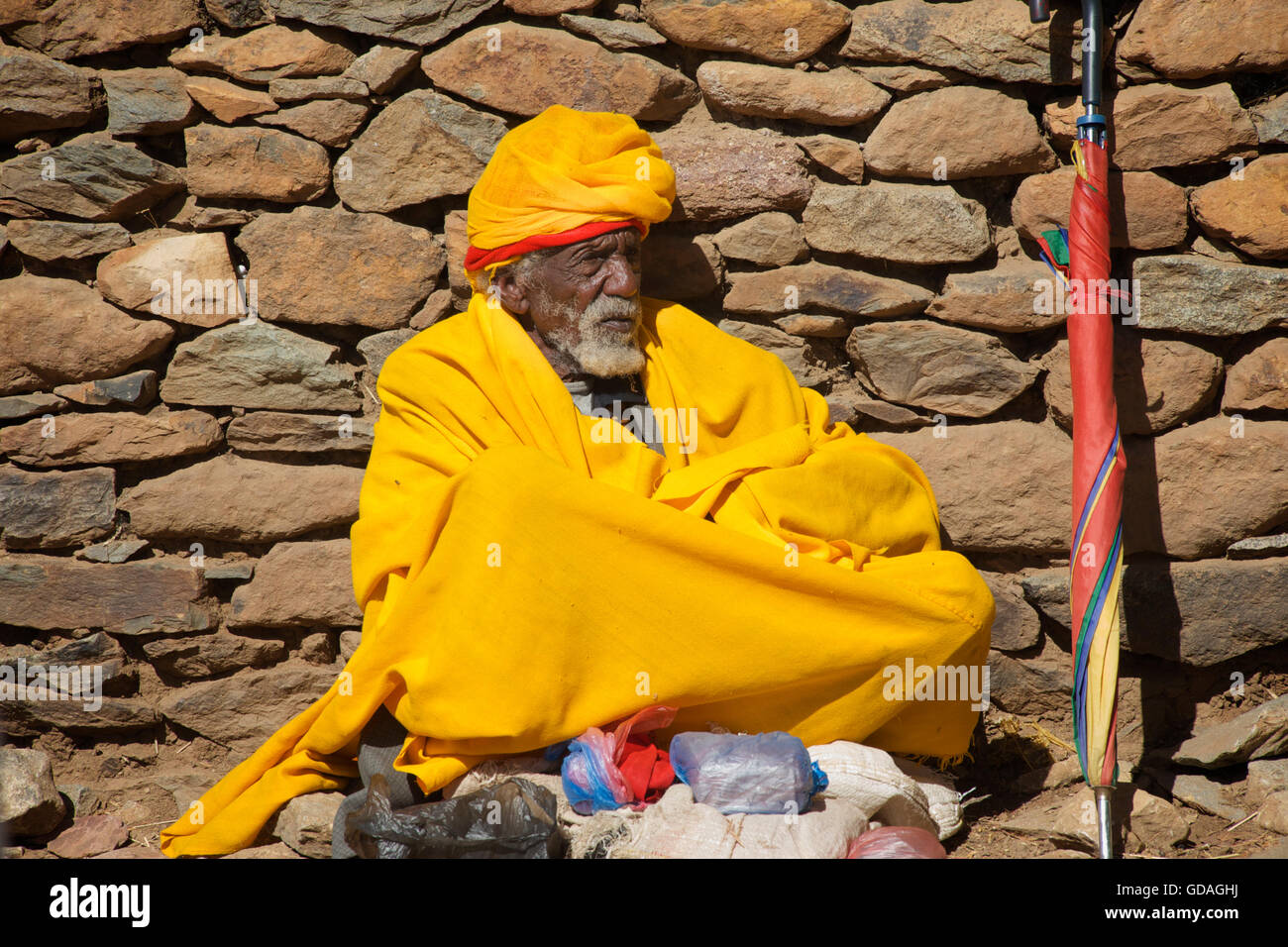 Christian pilgrim in yellow robes, Axum, Ethiopia. Yellow, the colour of the bahitawi hermits Stock Photo