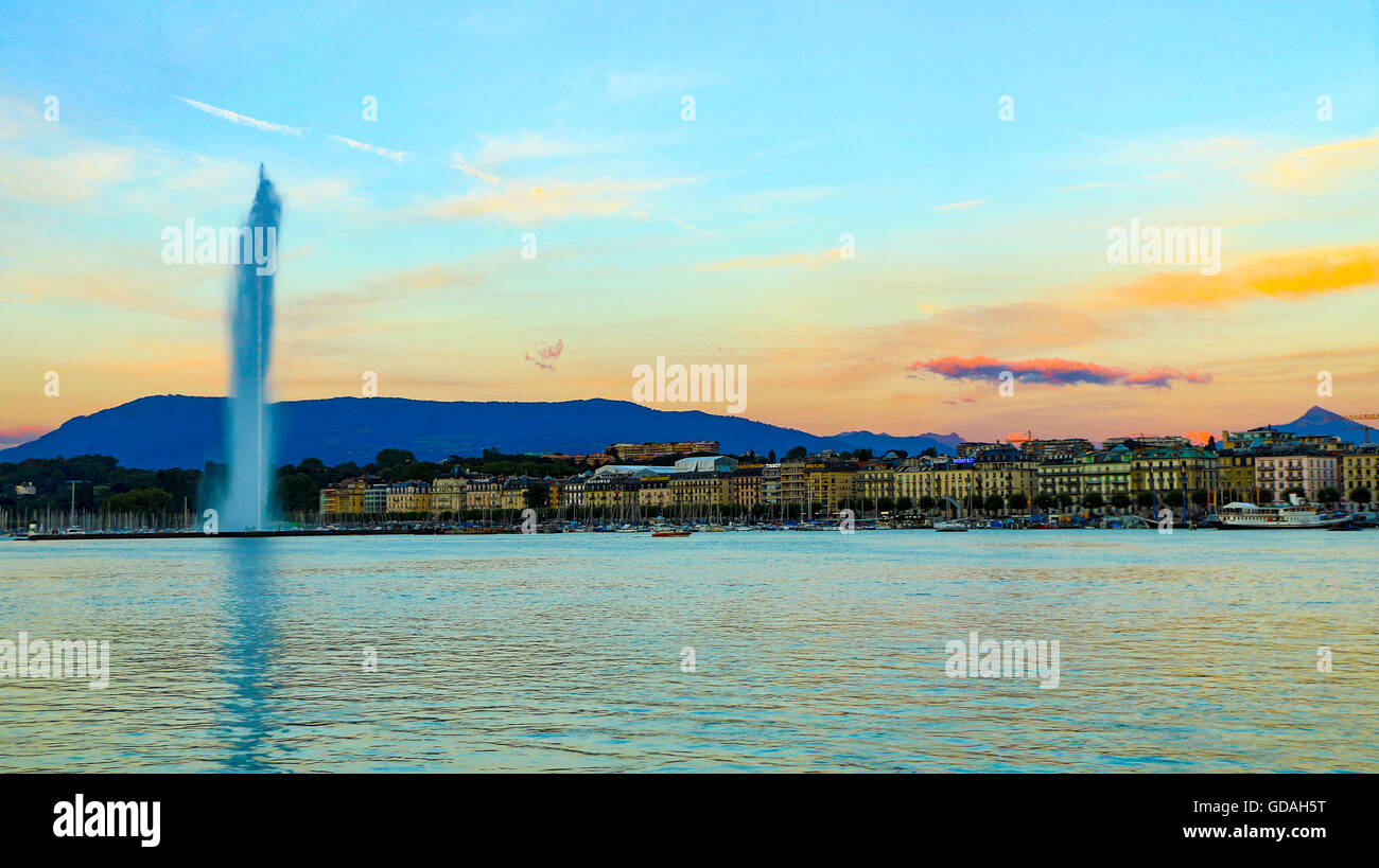 A view of Geneva's landmark as seen from Jardim Anlgais during a blue sky day.  The Jet d'Eau is a large fountain in Geneva, Swi Stock Photo