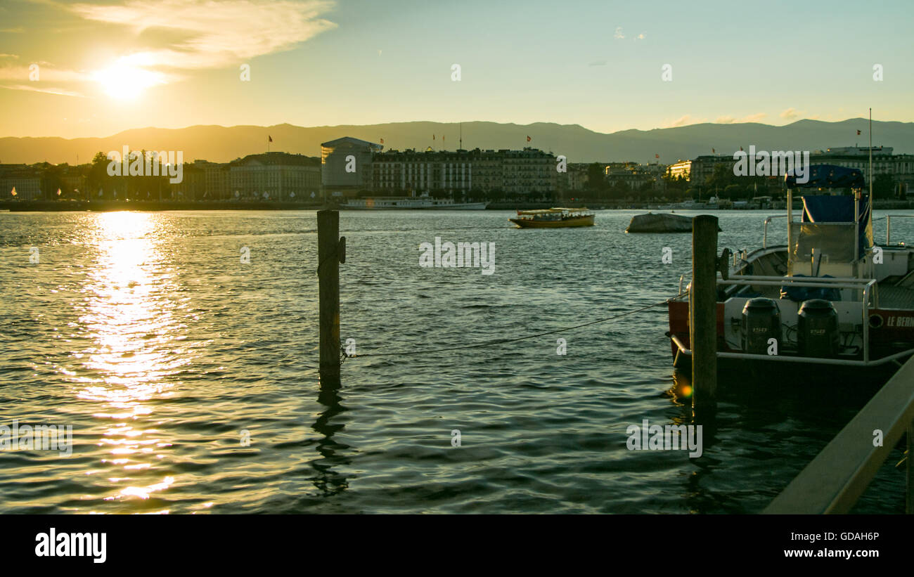 Sunset as seen from  Quai Gustave-Ador in Geneva, Switzerland. The neighbourhood you can see in front is Paquis. Stock Photo