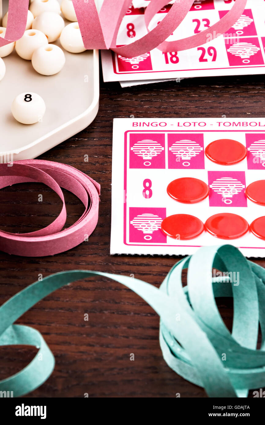 Bingo game with cards to play and serpentines. Vertical image. Stock Photo