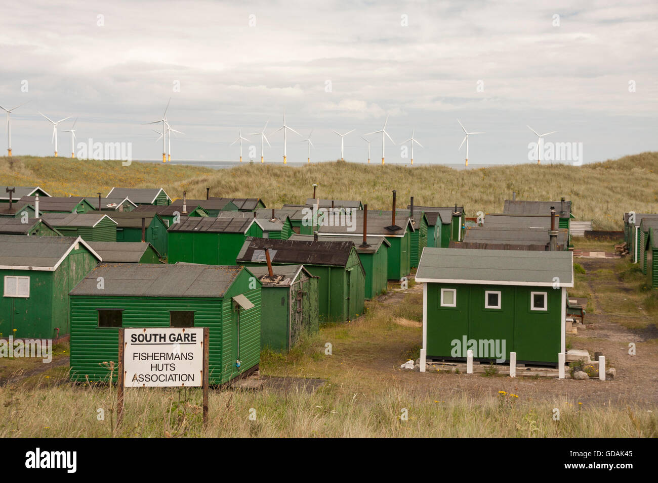 Fishermen's huts at South Gare,Redcar with the offshore wind turbines in the background Stock Photo