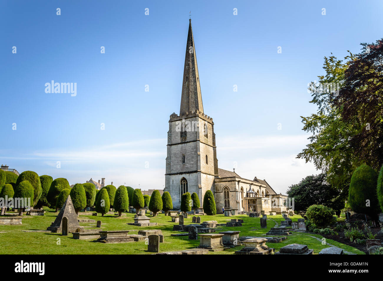 Painswick, UK - August 17, 2015: St Mary's Church and churchyard a blue sky day. Painswick is a town in the Cotswolds, originall Stock Photo