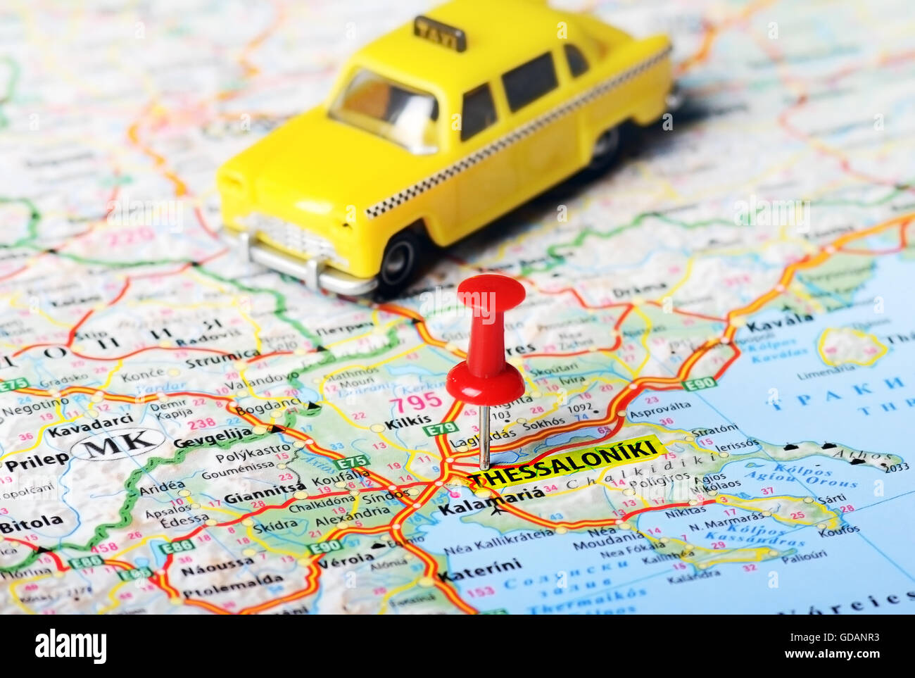Close up of  Thessaloniki  Greece map with red pin and a taxi toy - Travel concept Stock Photo