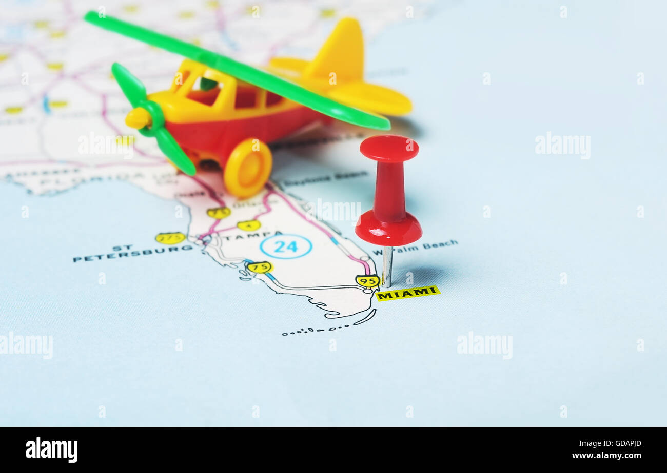 Close up of  Miami  USA map with red pin and airplane toy- Travel concept Stock Photo