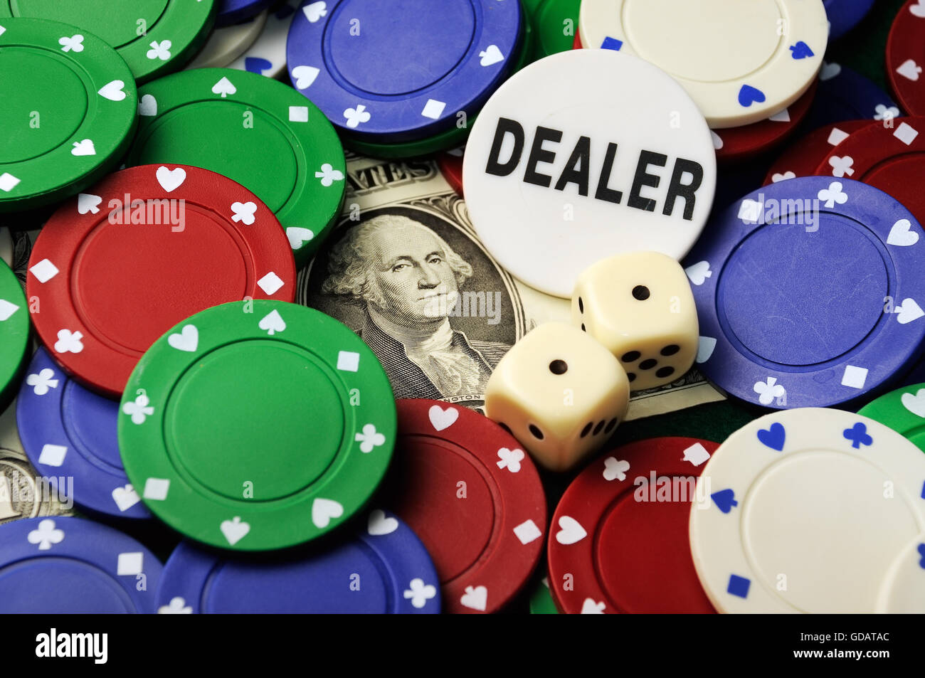 Dices ,chips , leather,dealer button cup and dollar bill on green cloth