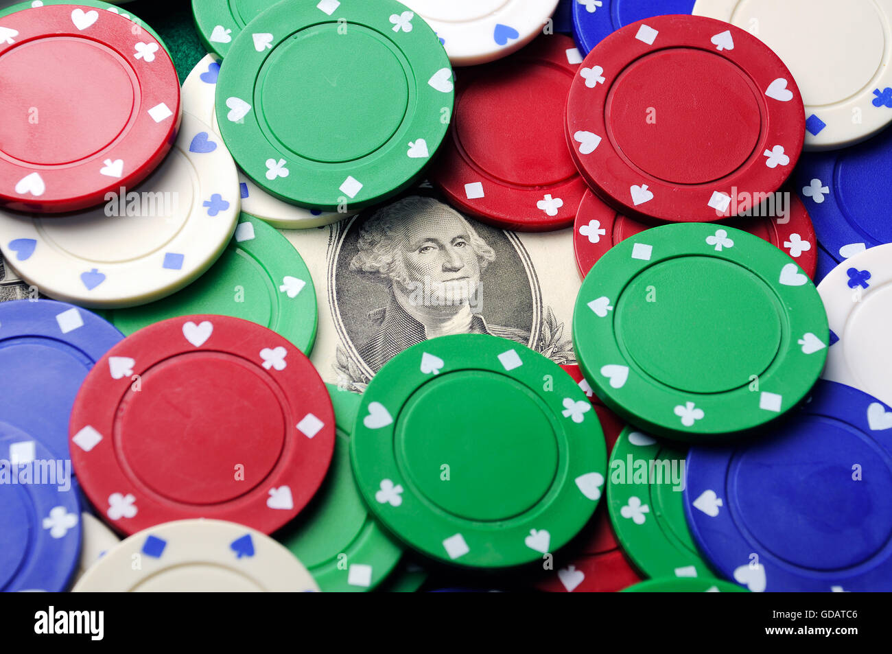dollar bill under poker chips economy concept Stock Photo Alamy
