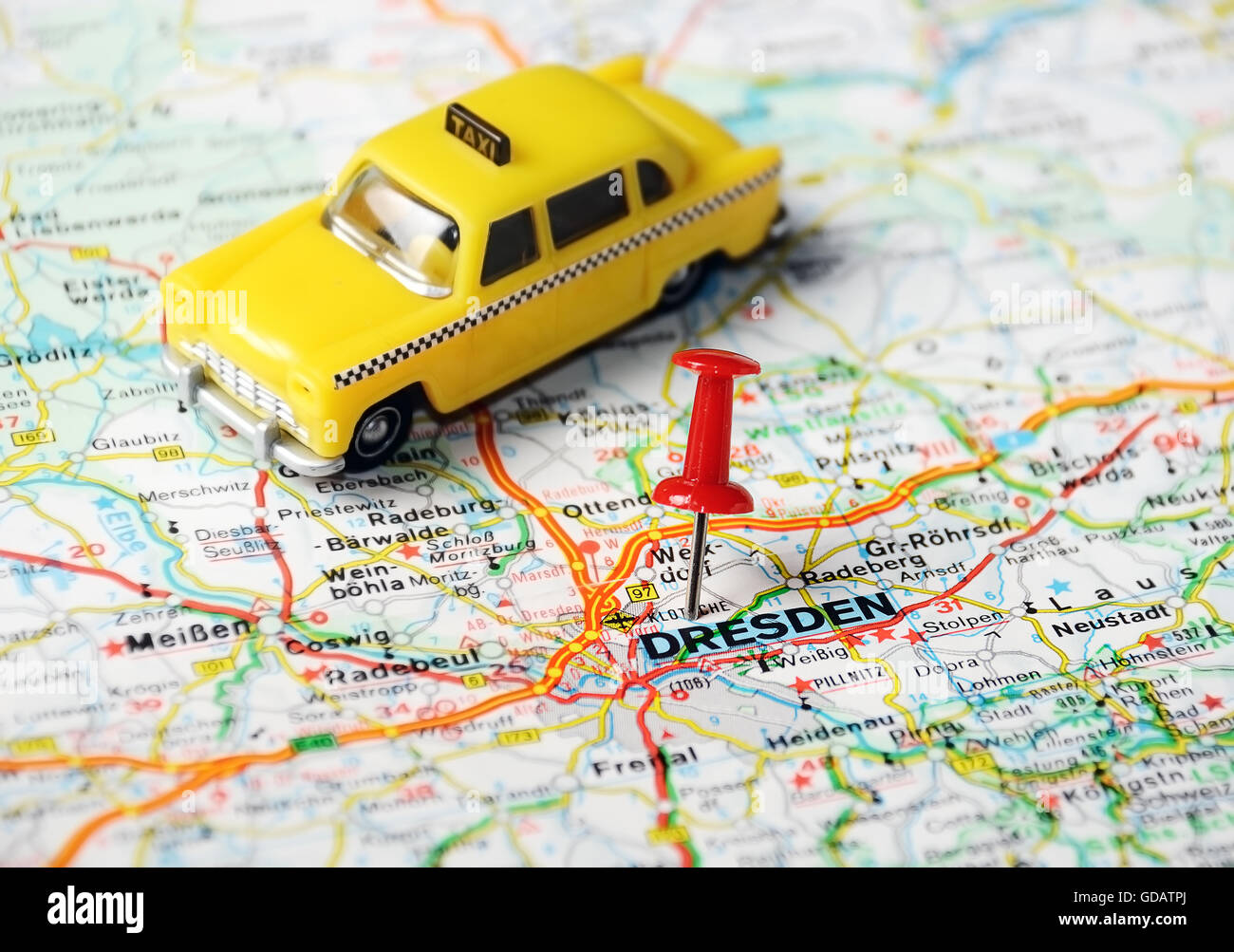 Close up of  Dresden  map with red pin and a taxi toy - Travel concept Stock Photo