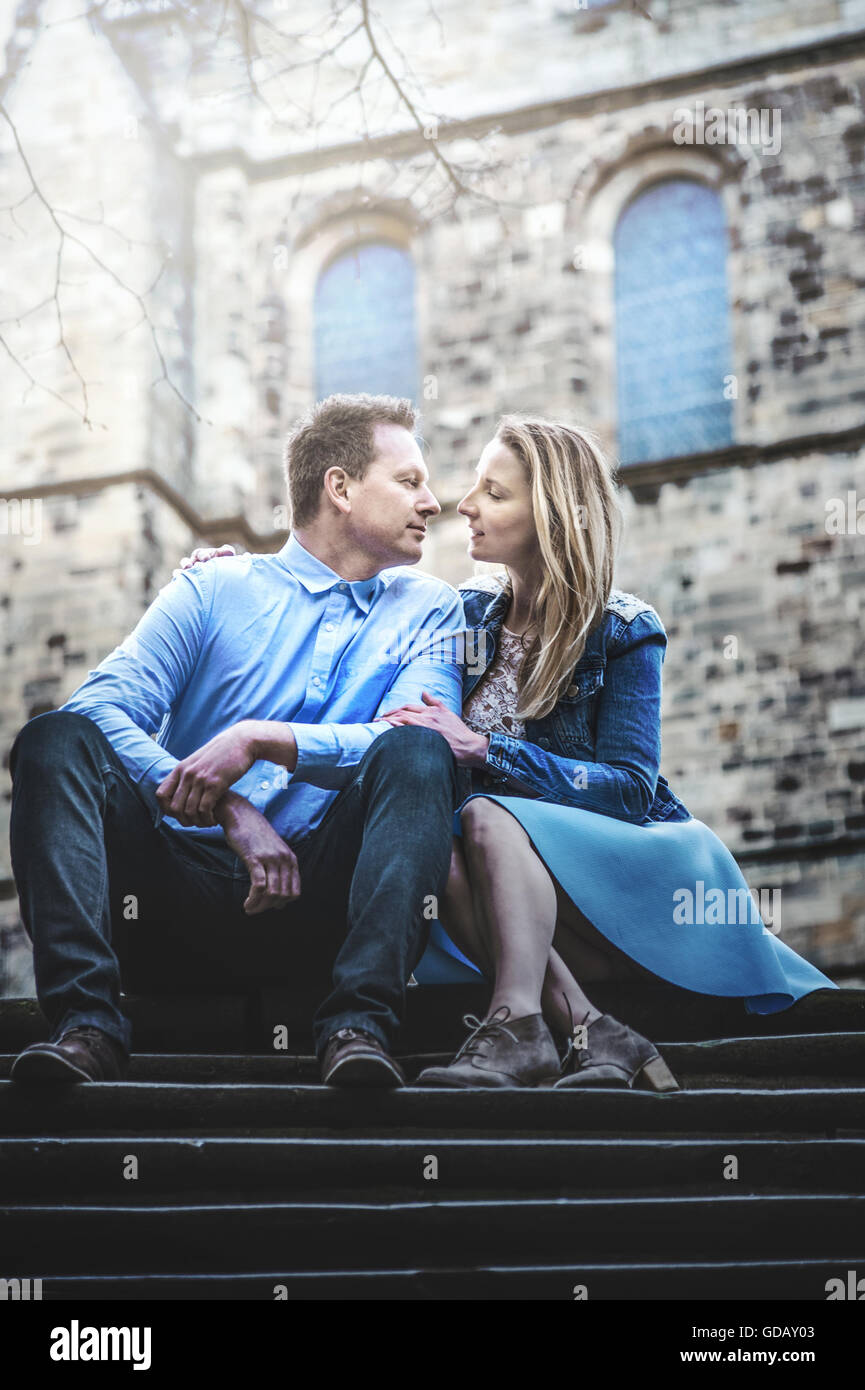 young couple sitting on stairs Stock Photo