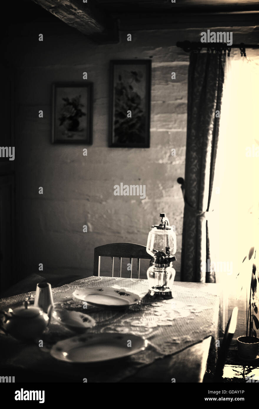 old cottage room with the table ,lamp,plates Stock Photo