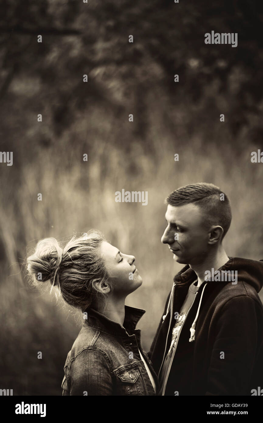 young couple in nature looking at each other with love Stock Photo