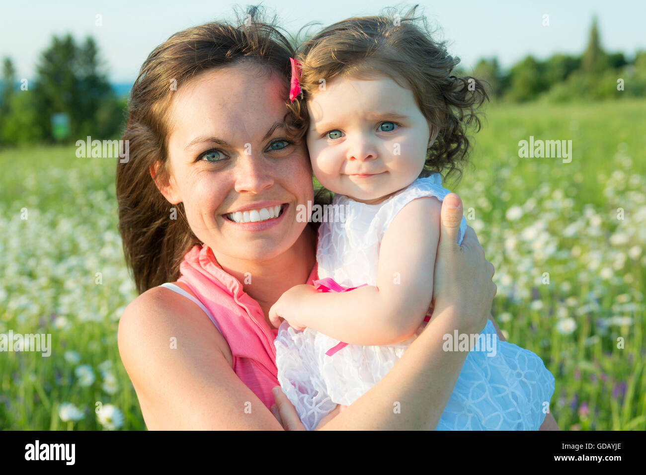 happy joyful mother with daughter daisy field Stock Photo