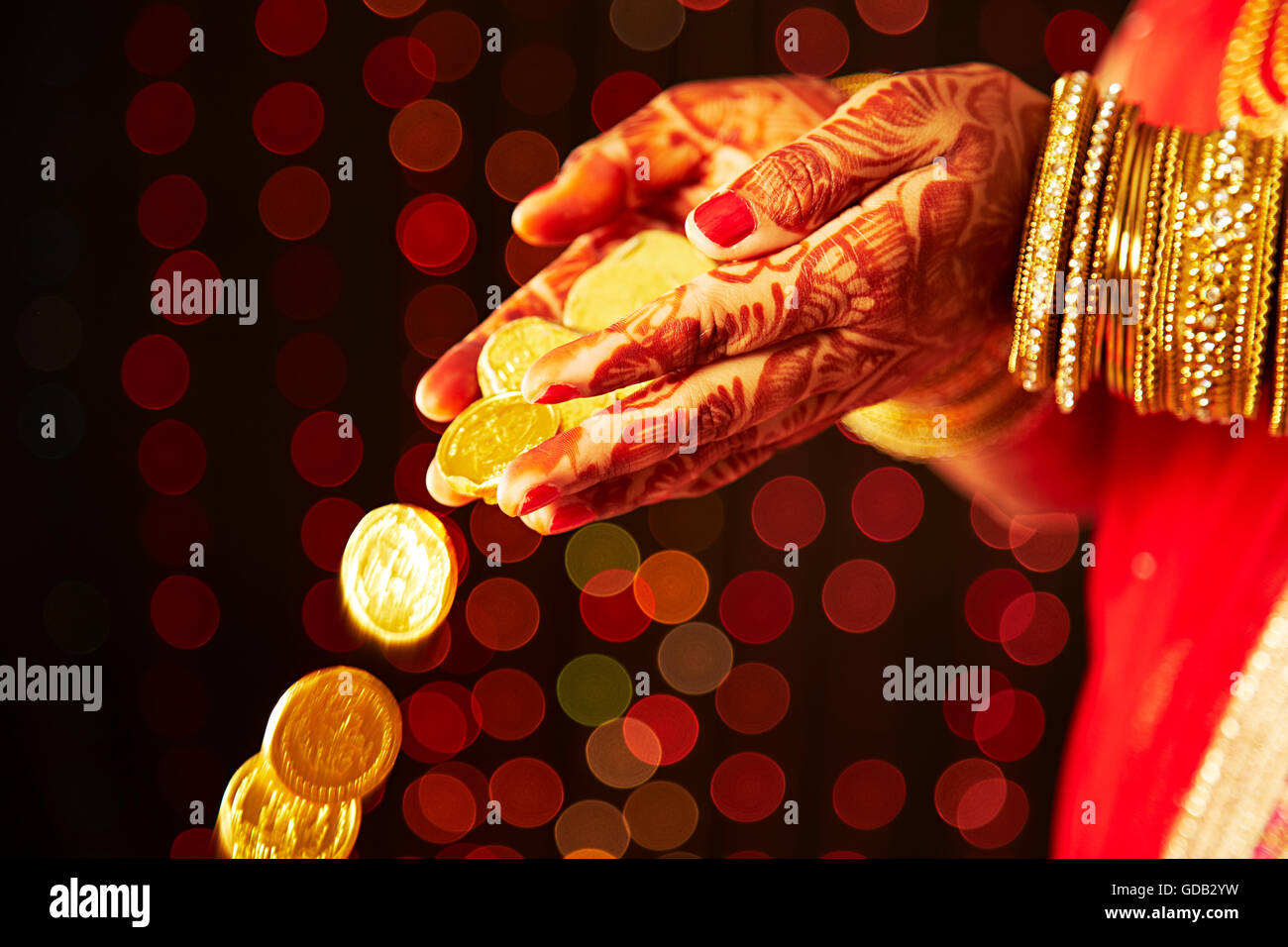 1 indian Adult Woman Bride Hands-cupped Gold Coin Pouring Stock Photo
