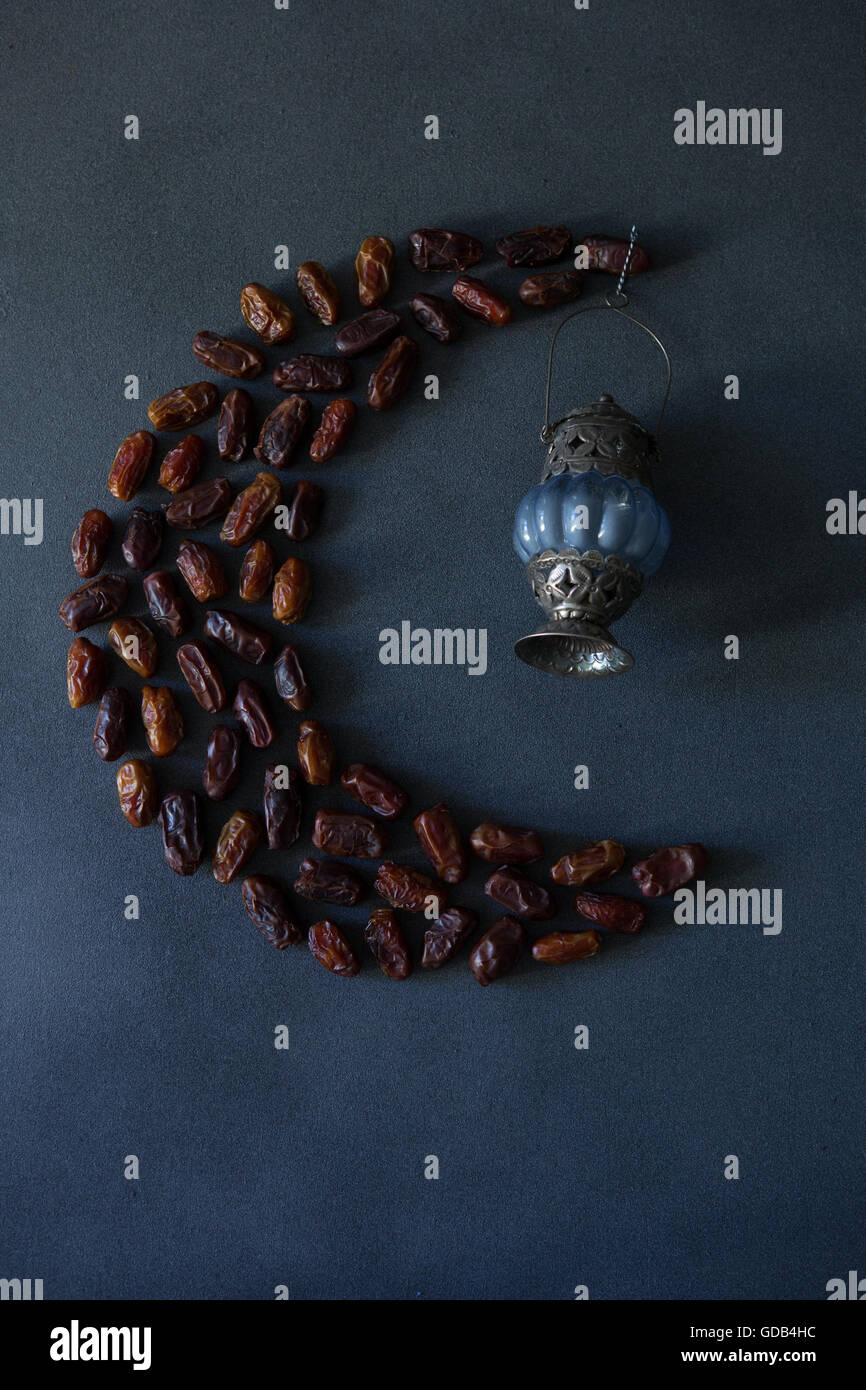 Dates in the shape of a crescent moon, with a blue and silver lantern ...
